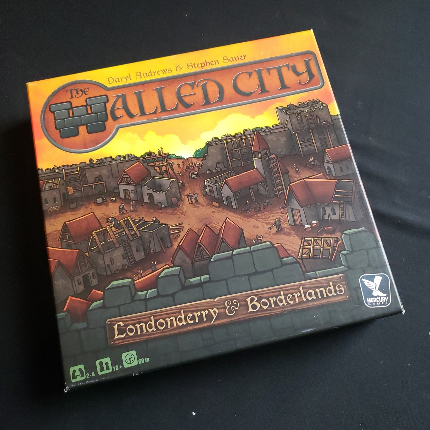 Image shows the front cover of the box of the Walled City board game