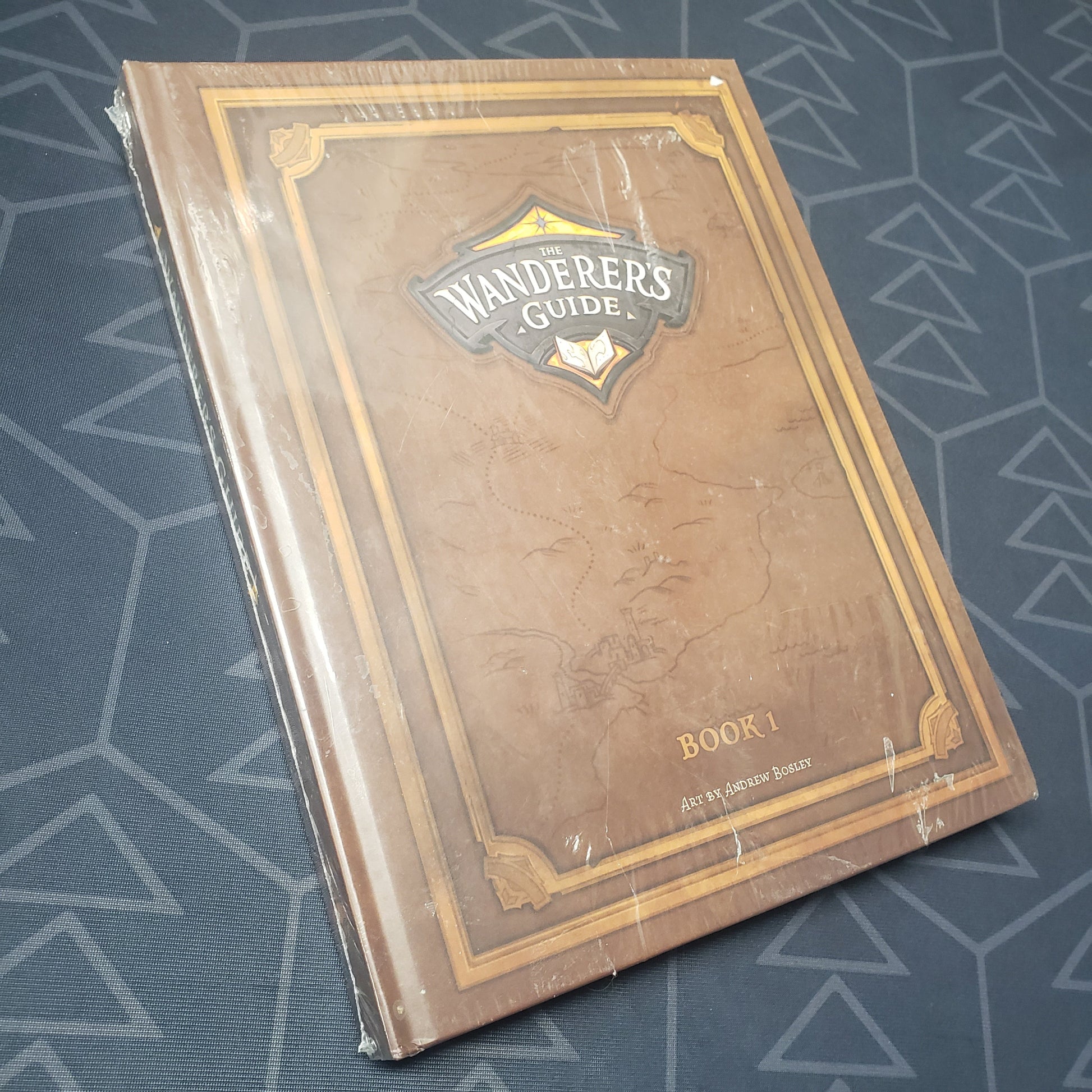 Image shows the front cover of The Wanderer's Guide roleplaying game book