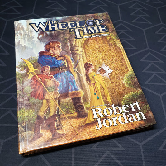 Image shows the front cover of the core rulebook for the roleplaying game The Wheel of Time