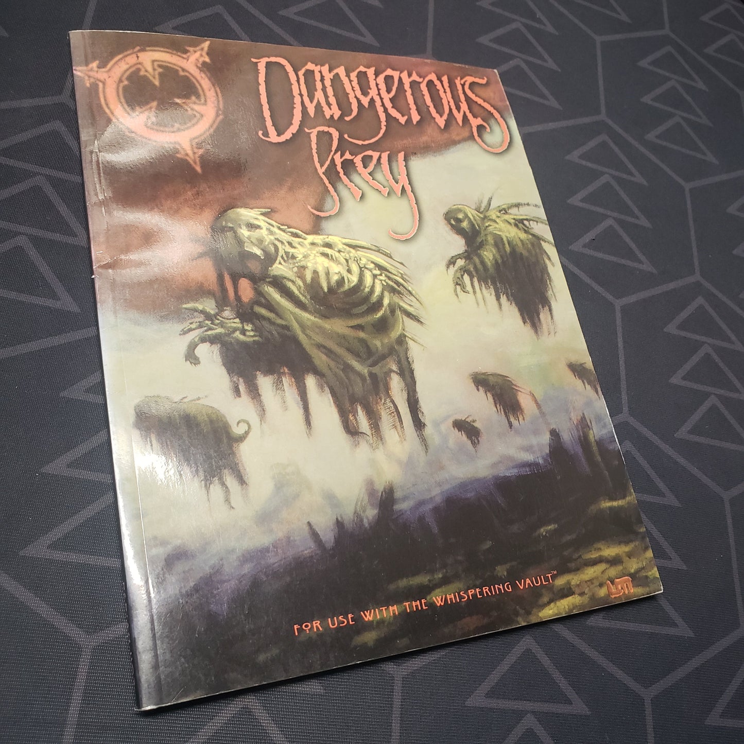 Image shows the front cover of the Dangerous Prey book for the roleplaying game The Whispering Vault
