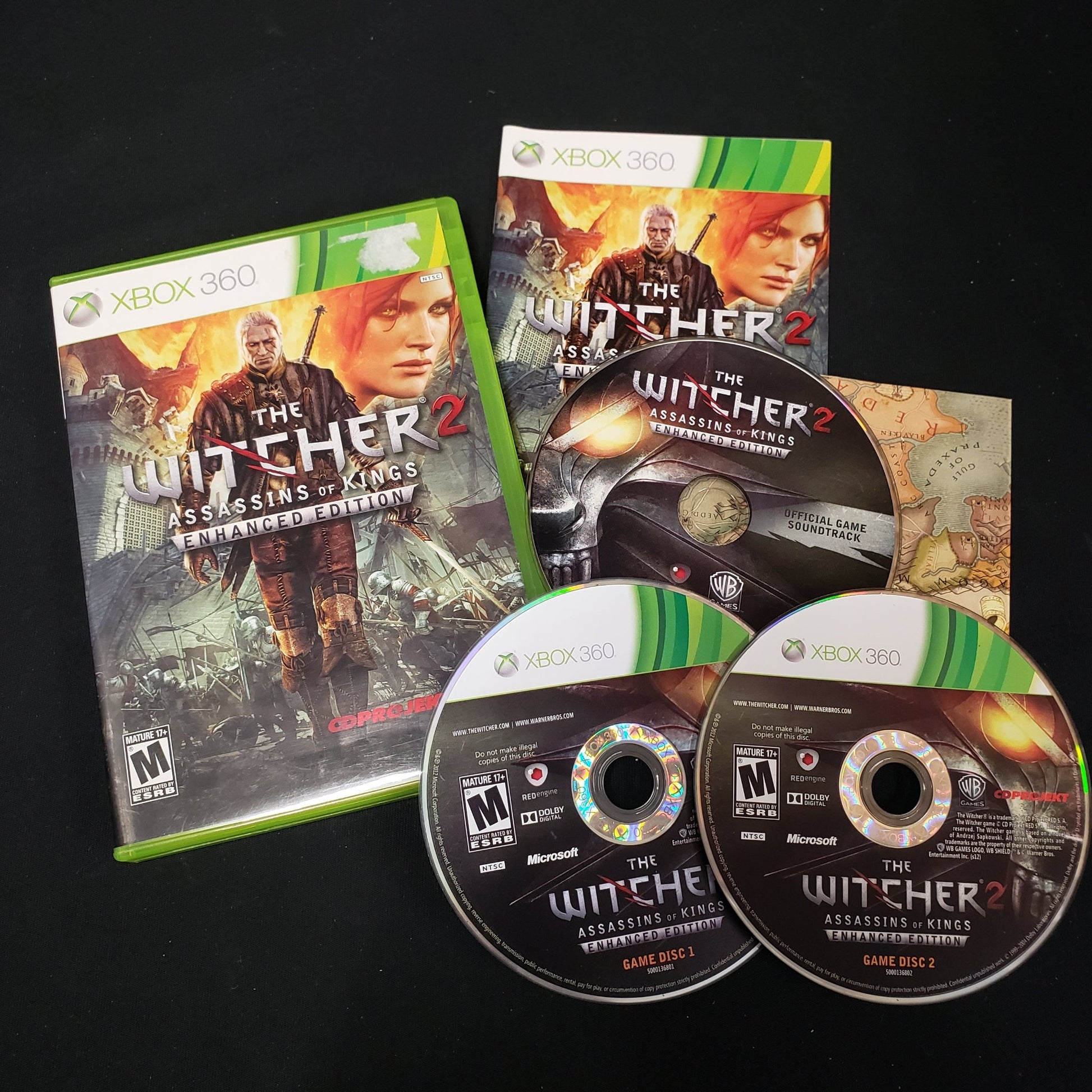 Image shows the case, manual, map & discs for the video game The Witcher 2 for Xbox 360