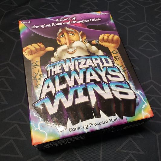 Image shows the front cover of the box for the board game The Wizard Always Wins