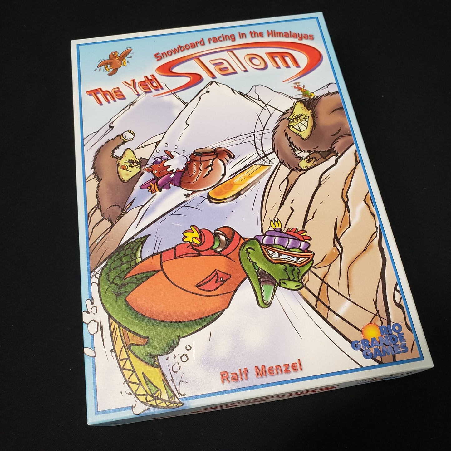 Image shows the front cover of the box of the Yeti Slalom board game