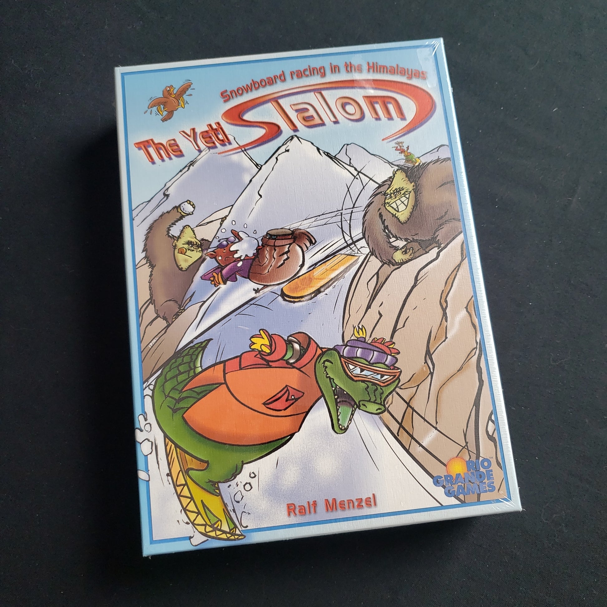 Image shows the front cover of the box of the Yeti Slalom board game