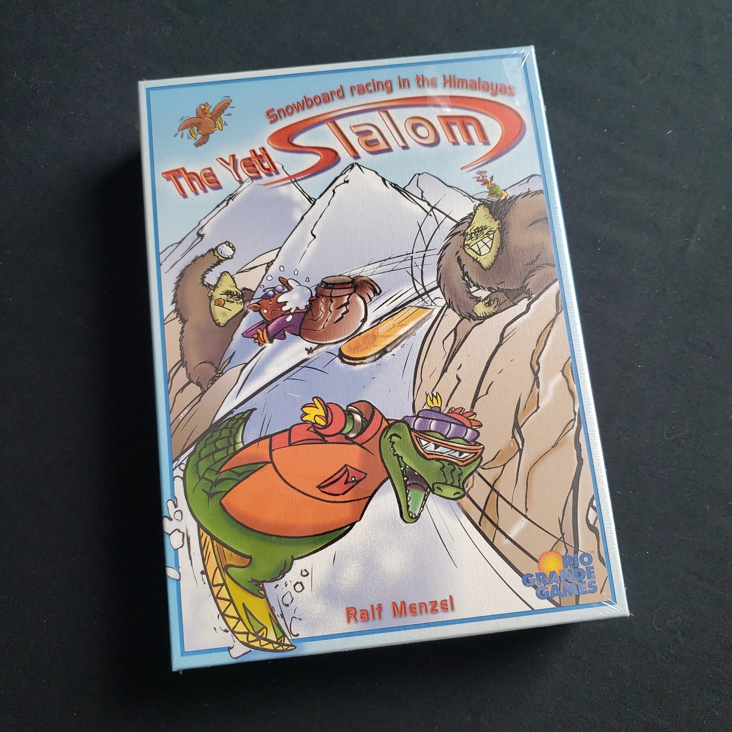 Image shows the front cover of the box of the Yeti Slalom board game