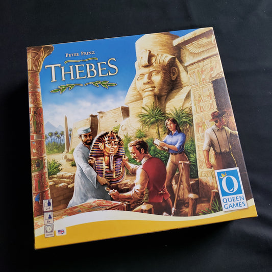 Image shows the front cover of the box of the Thebes board game