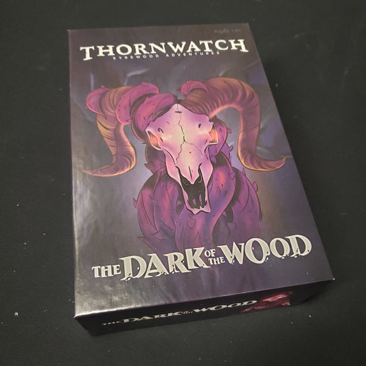 Image shows the front cover of the box of the Dark of the Wood expansion for the board game Thornwatch