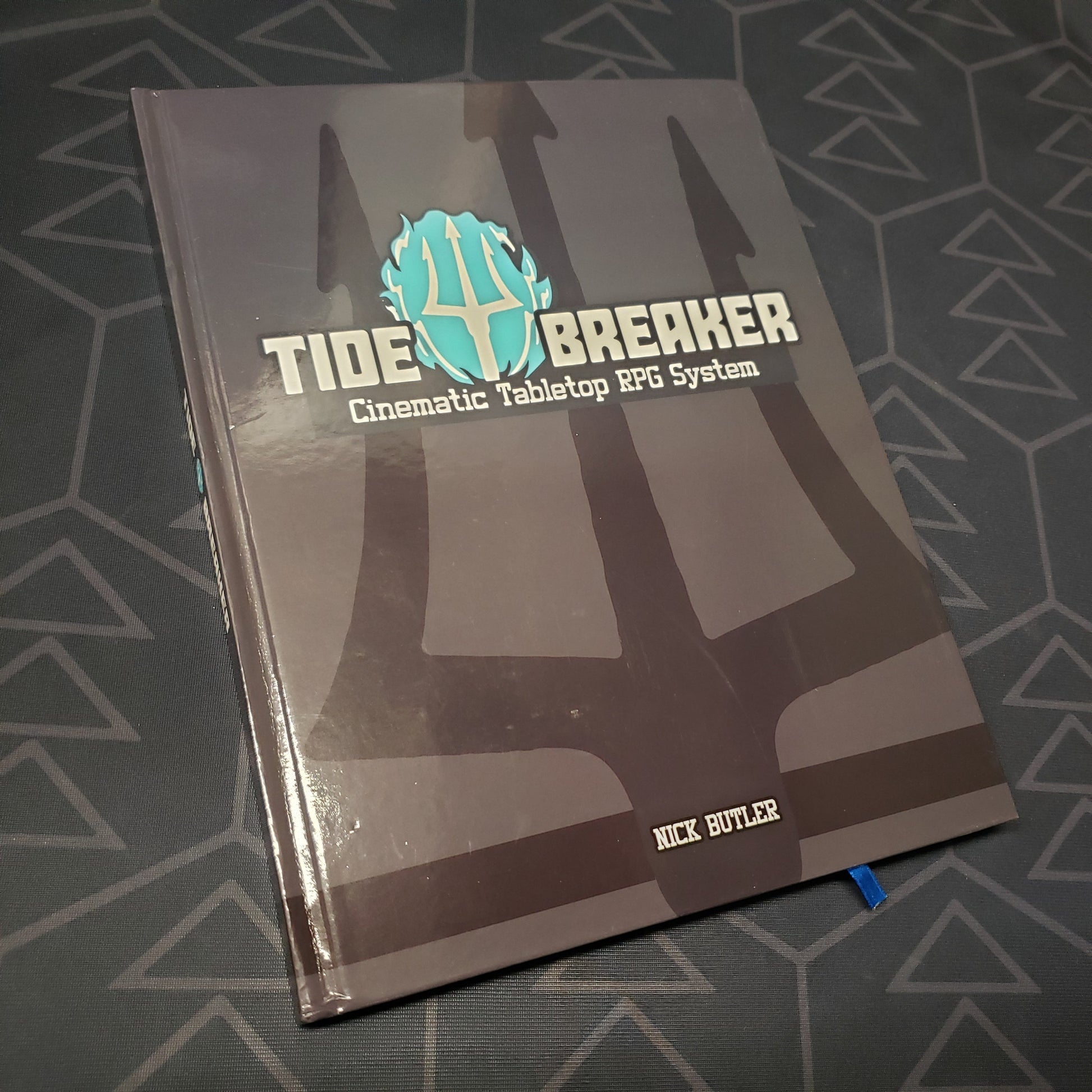 Image shows the front cover of the core rulebook for the roleplaying game Tide Breaker