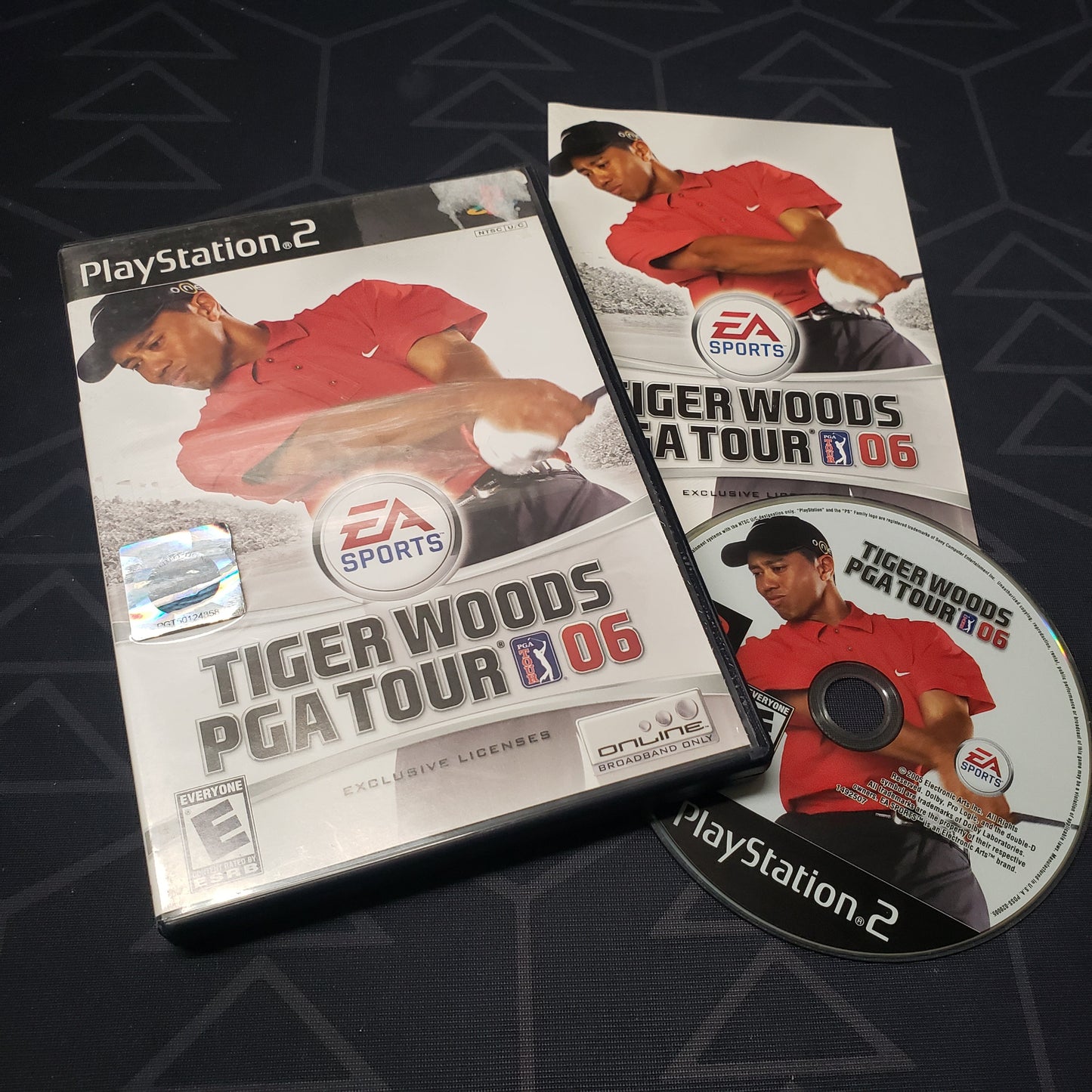 Image shows the case, manual and disc for the video game Tiger Woods PGA Tour 06 for the original Xbox