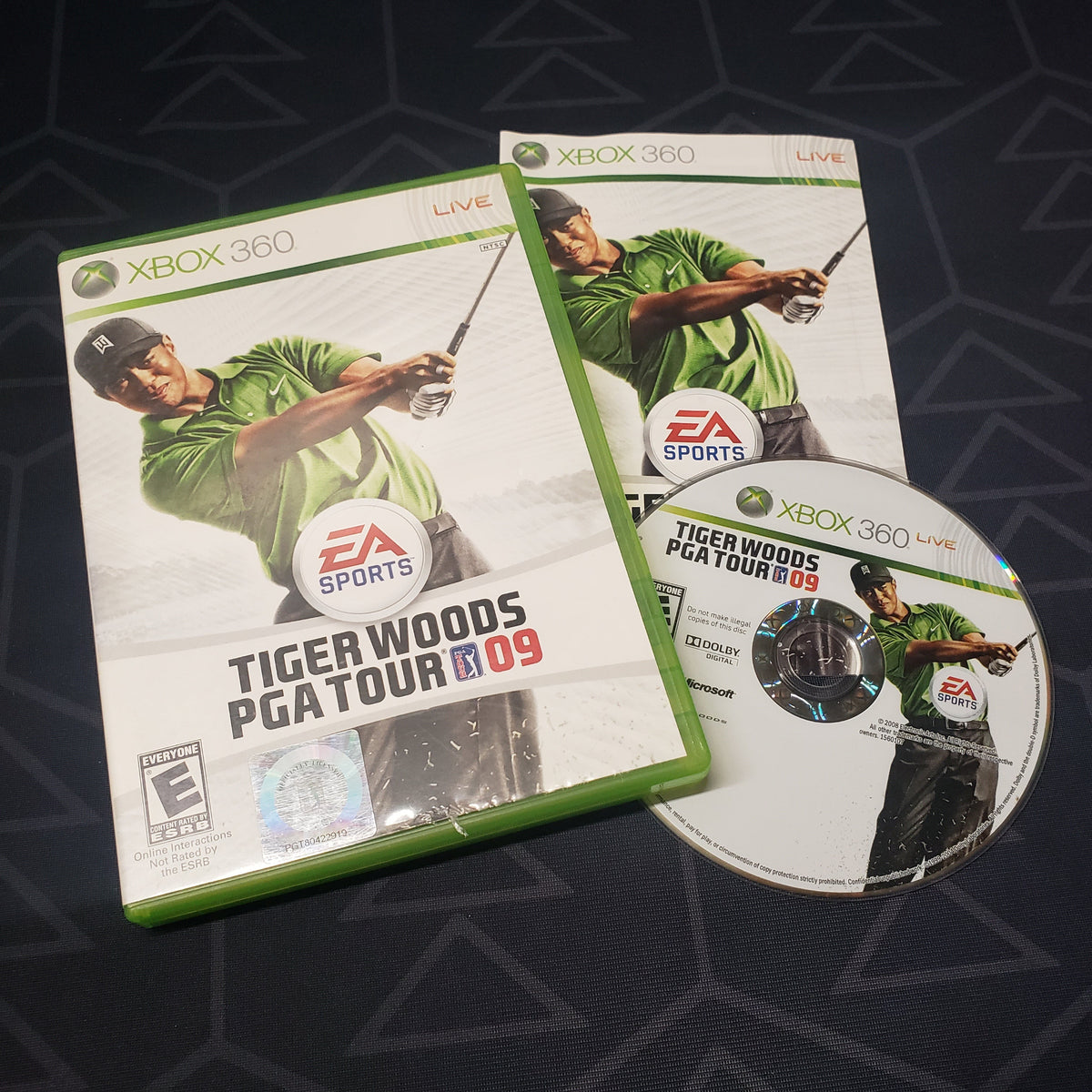 Image shows the case, manual and disc for the video game Tiger Woods PGA Tour 09 for Xbox 360