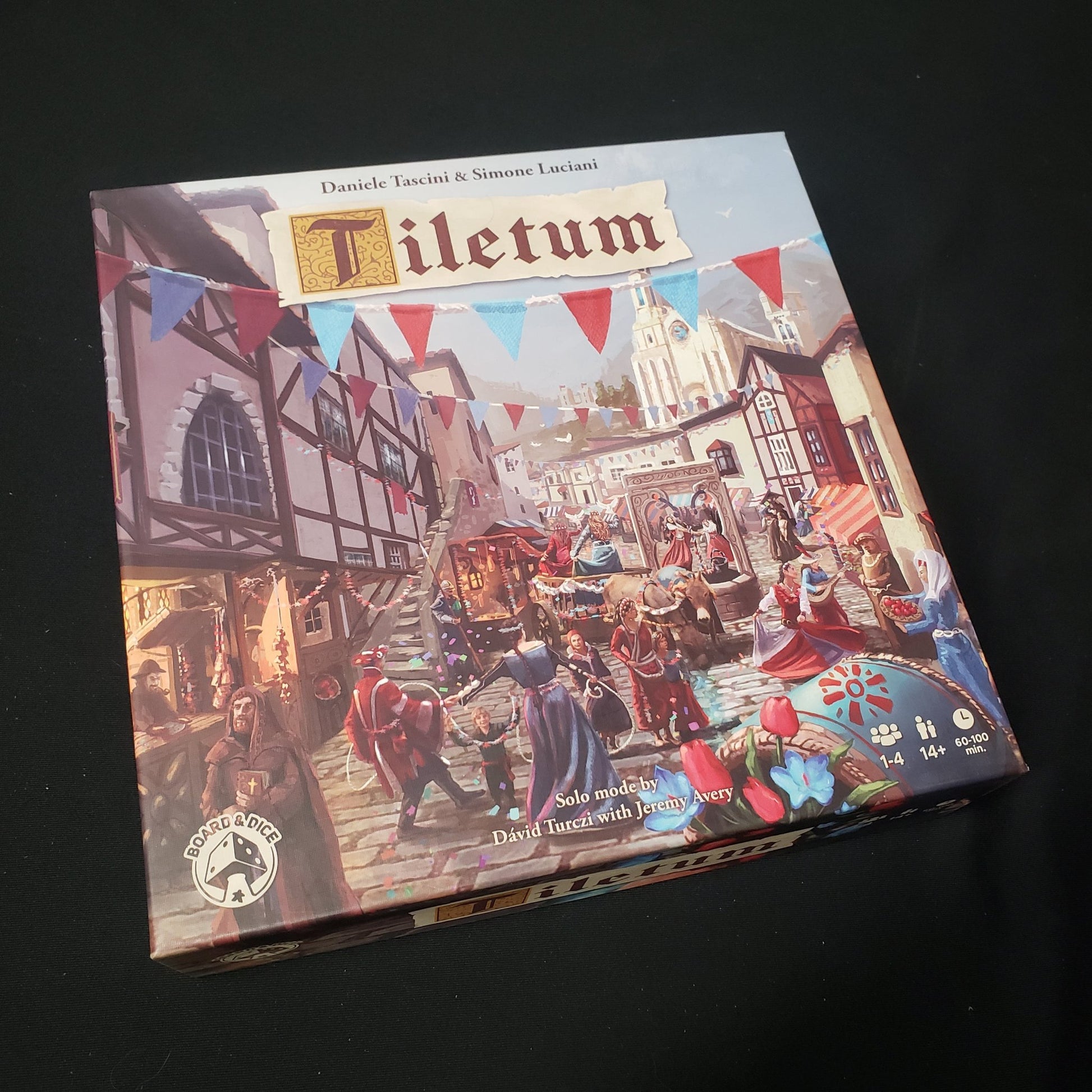 Image shows the front cover of the box of the Tiletum board game