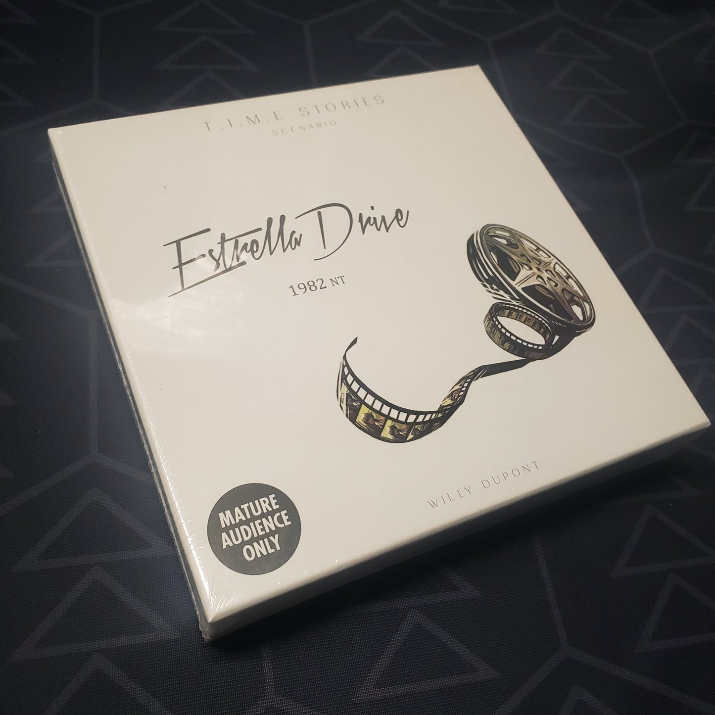 Image shows the front cover of the box of the Estrella Drive expansion for the board game T.I.M.E Stories