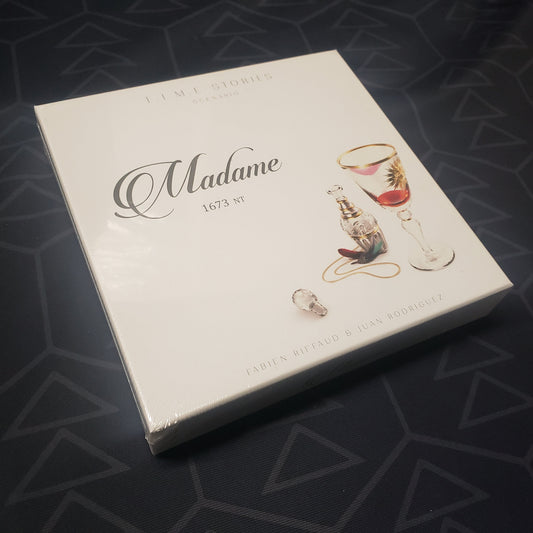 Image shows the front cover of the box of the Madame expansion for the board game T.I.M.E Stories