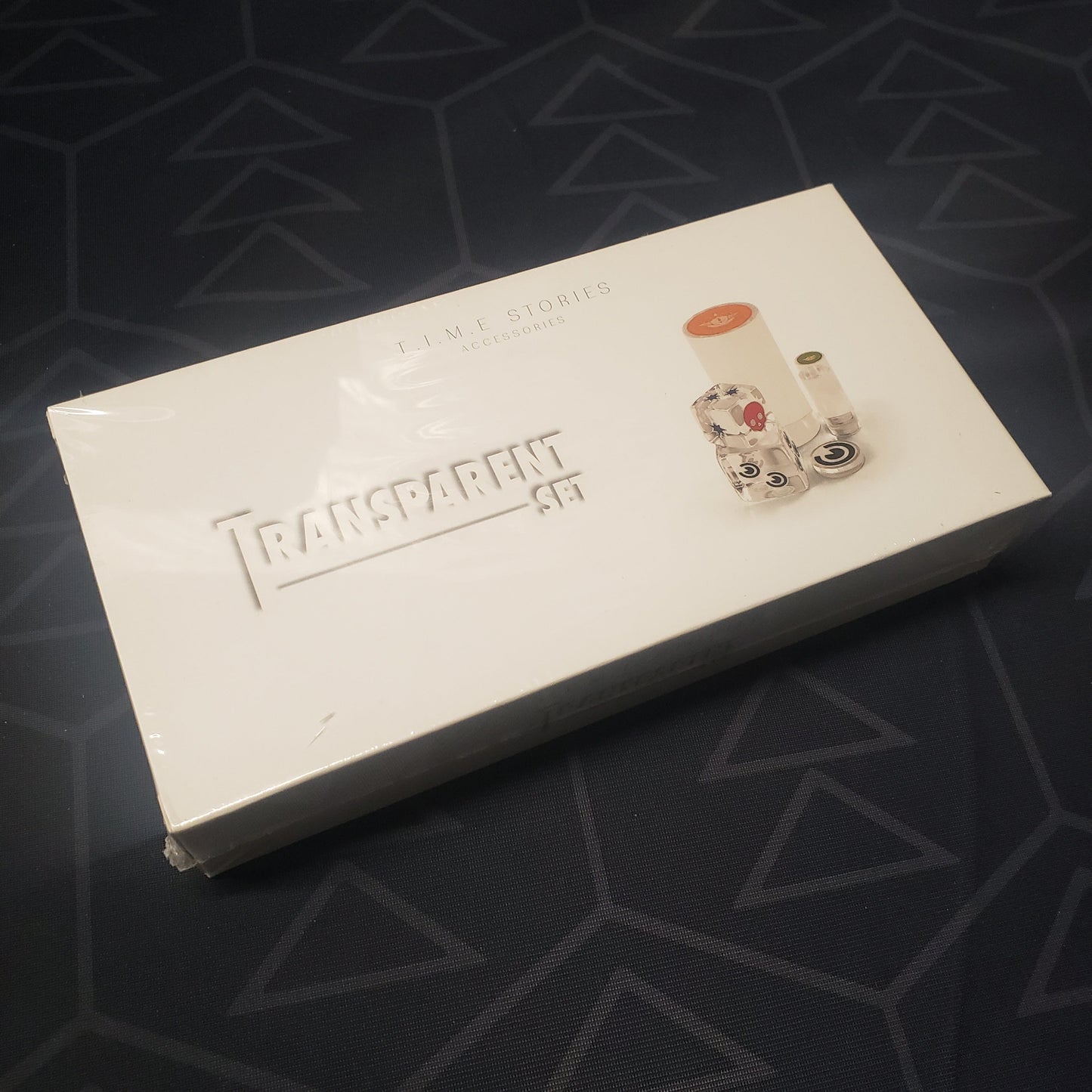 Image shows the front cover of the box of the Transparent Set expansion for the board game T.I.M.E Stories