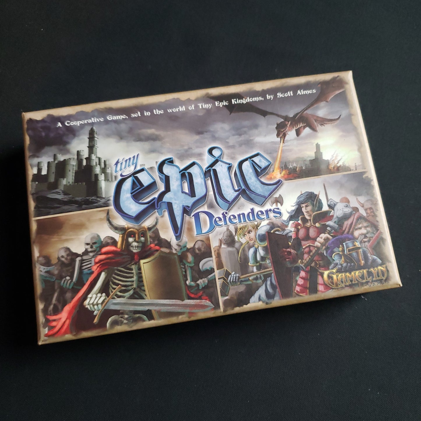 Image shows the front cover of the box of the Tiny Epic Defenders board game