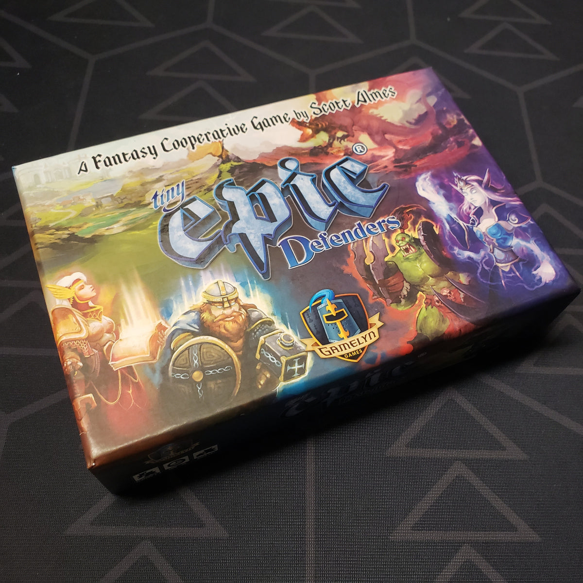 Image shows the front cover of the box for the Tiny Epic Defenders (Second Edition) board game