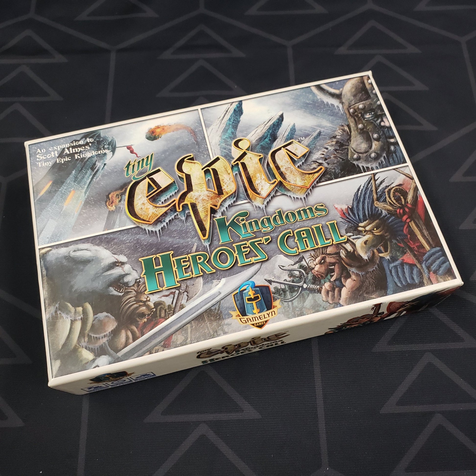 Image shows the front cover of the box of the Heroes' Call expansion for the board game Tiny Epic Kingdoms