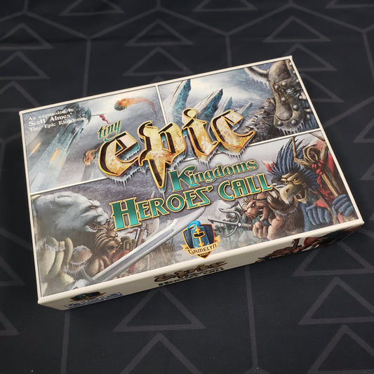 Image shows the front cover of the box of the Heroes' Call expansion for the board game Tiny Epic Kingdoms