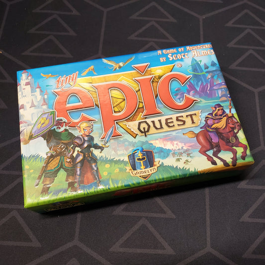 Image shows the front cover of the box for the Tiny Epic Quest board game