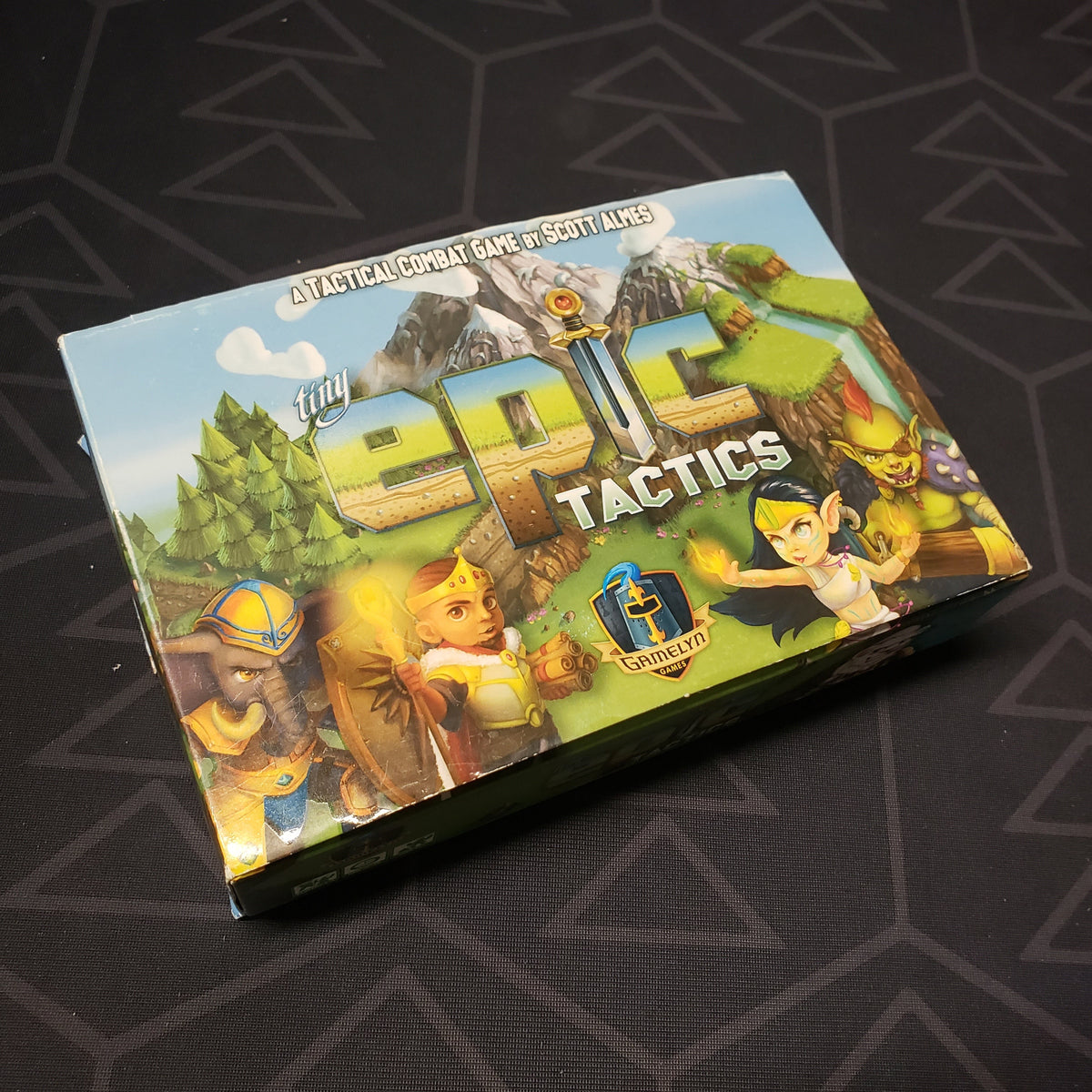 Image shows the front cover of the box for the Tiny Epic Tactics board game