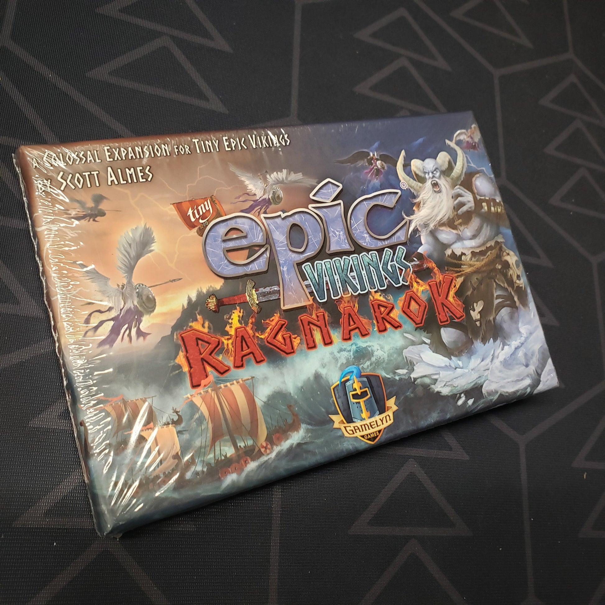 Image shows the front cover of the box of the Ragnarok expansion for the board game Tiny Epic Vikings