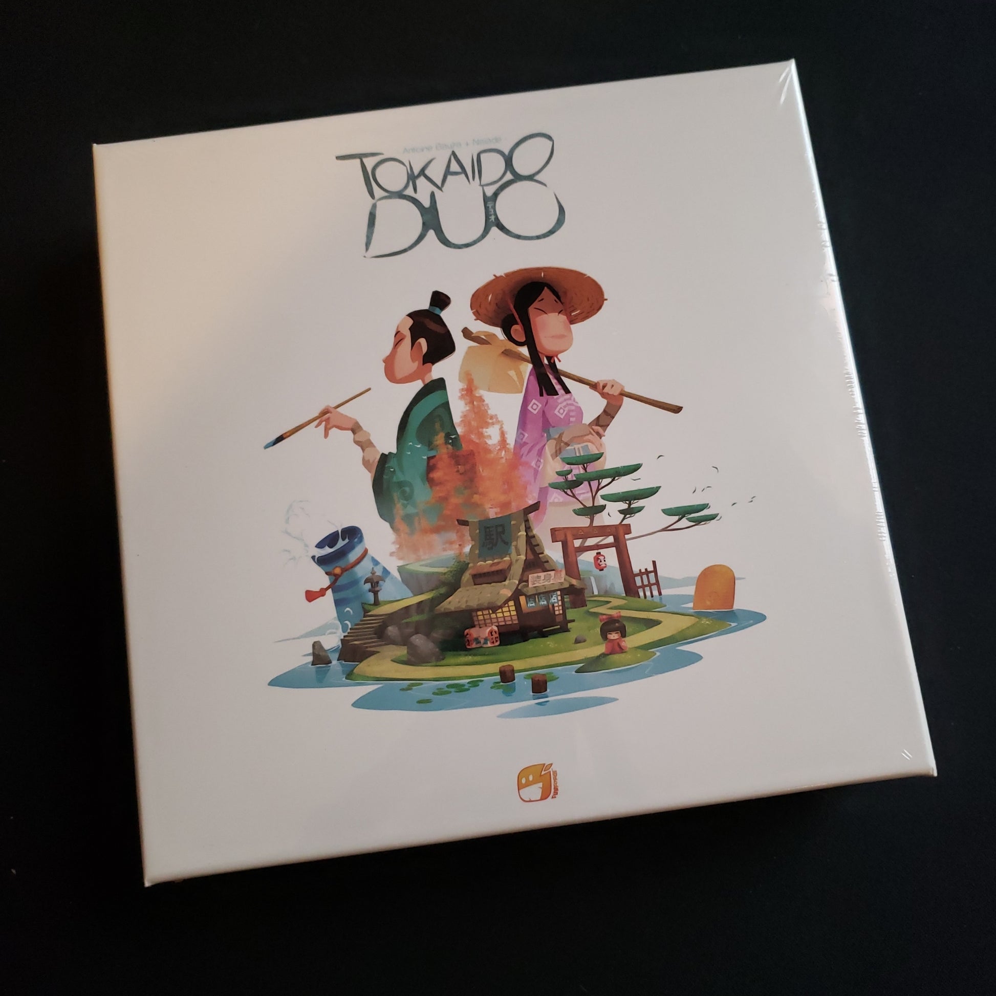 Image shows the front cover of the box of the Tokaido Duo board game