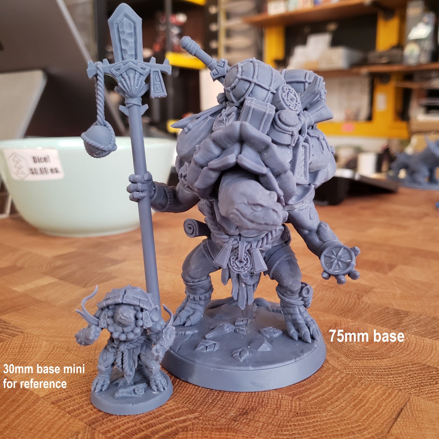 Image shows an example of a large 3D printed turtle merchant gaming miniature printed in-house at All Systems Go, sitting next to a small turtle miniature for reference