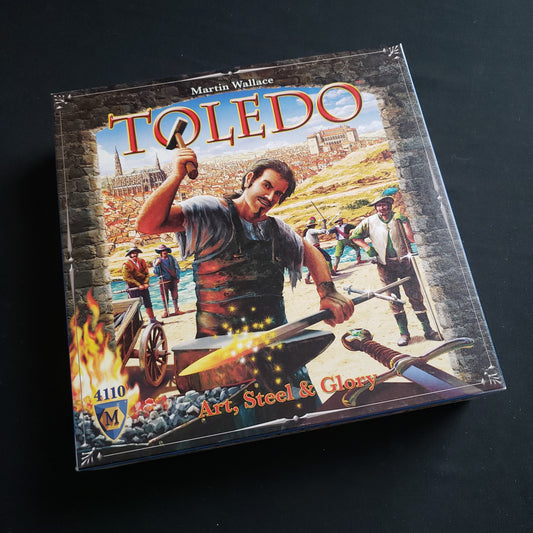 Image shows the front cover of the box of the Toledo board game