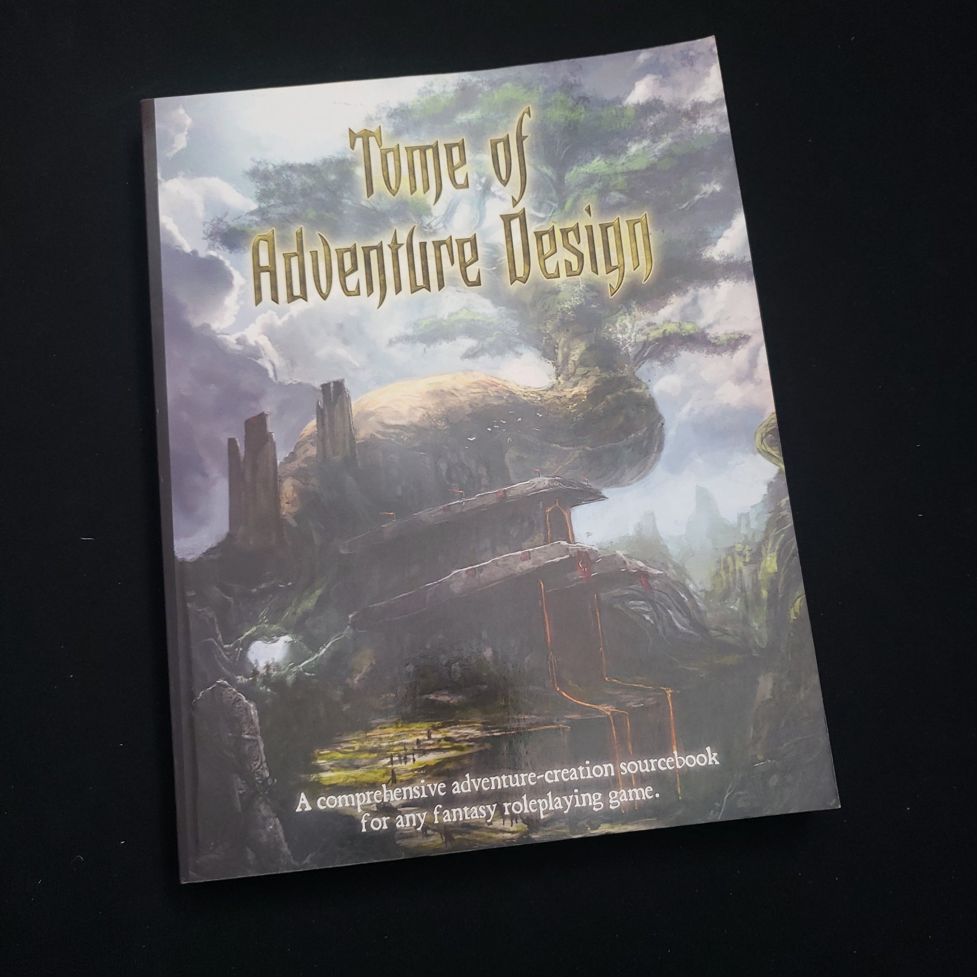 Image shows the front cover of the Tome of Adventure Design roleplaying game book