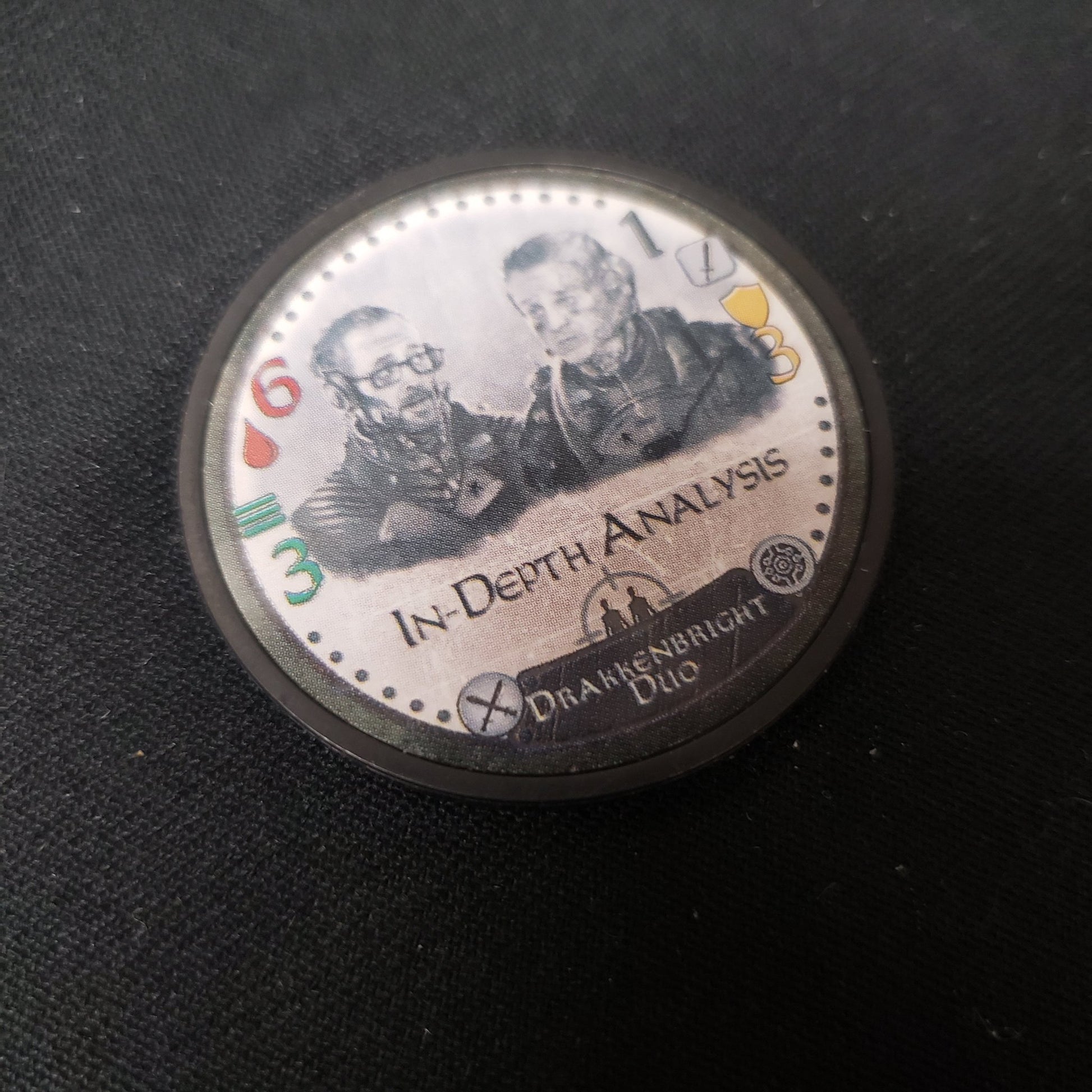Image shows the Drakkenbright Duo promo expansion chip from the board game Too Many Bones