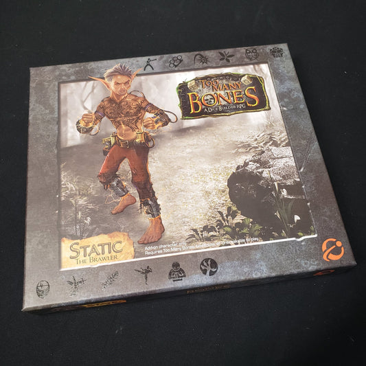 Image shows the front cover of the box for the Static expansion from the board game Too Many Bones