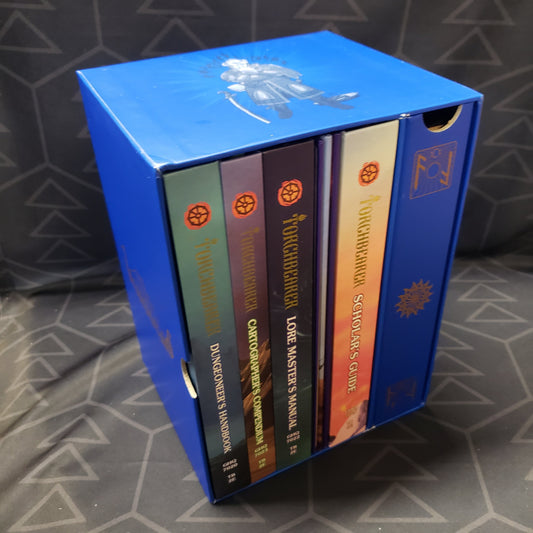image shows the side profile with the book spines that make up the Game Master's Edition box set for the roleplaying game Torchbearer: Second Edition