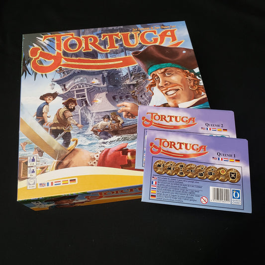 Image shows the front cover of the box of the Tortuga board game, with the instructions for the Queenie #1 & #2 expansions sitting on top of it