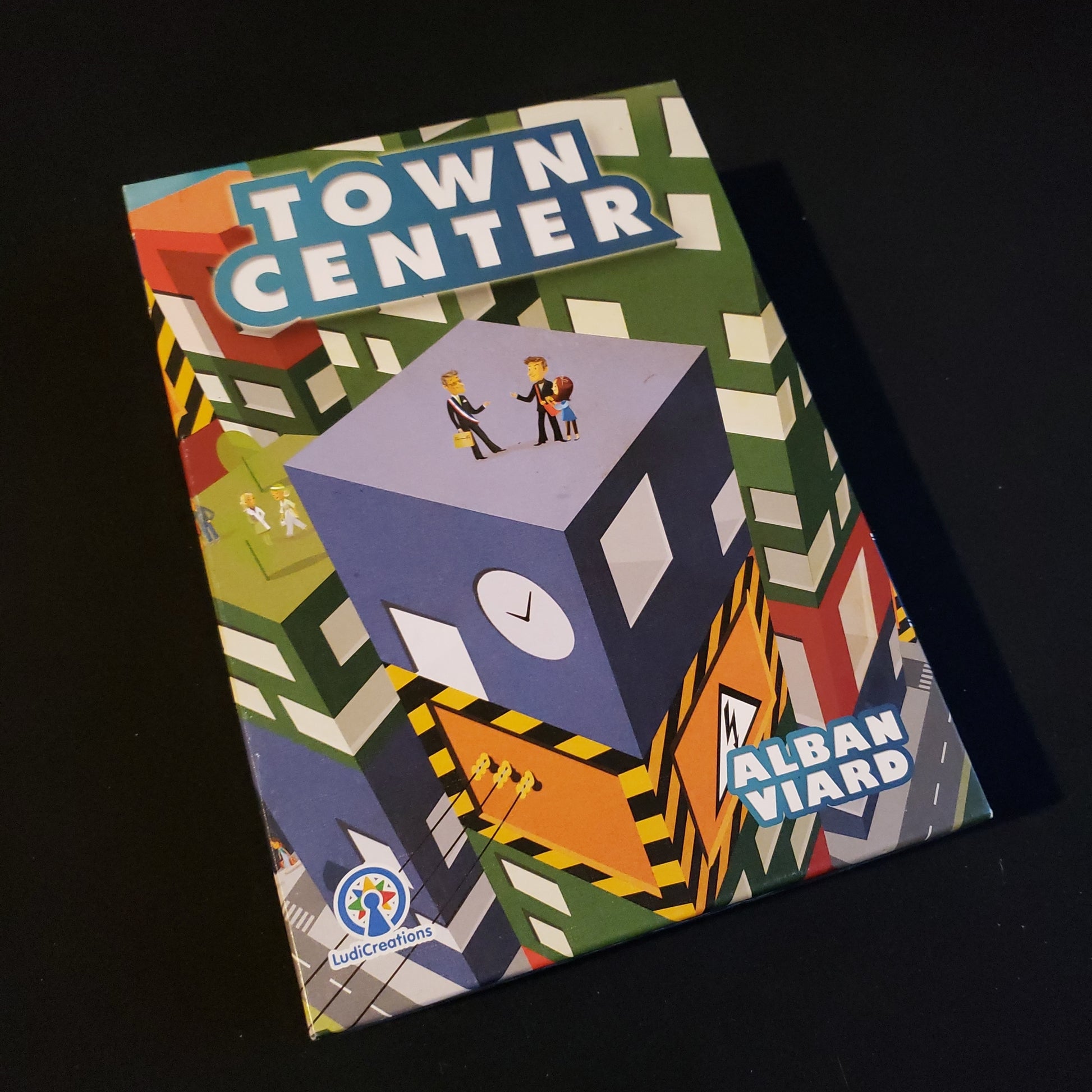 Image shows the front cover of the box of the Town Center board game
