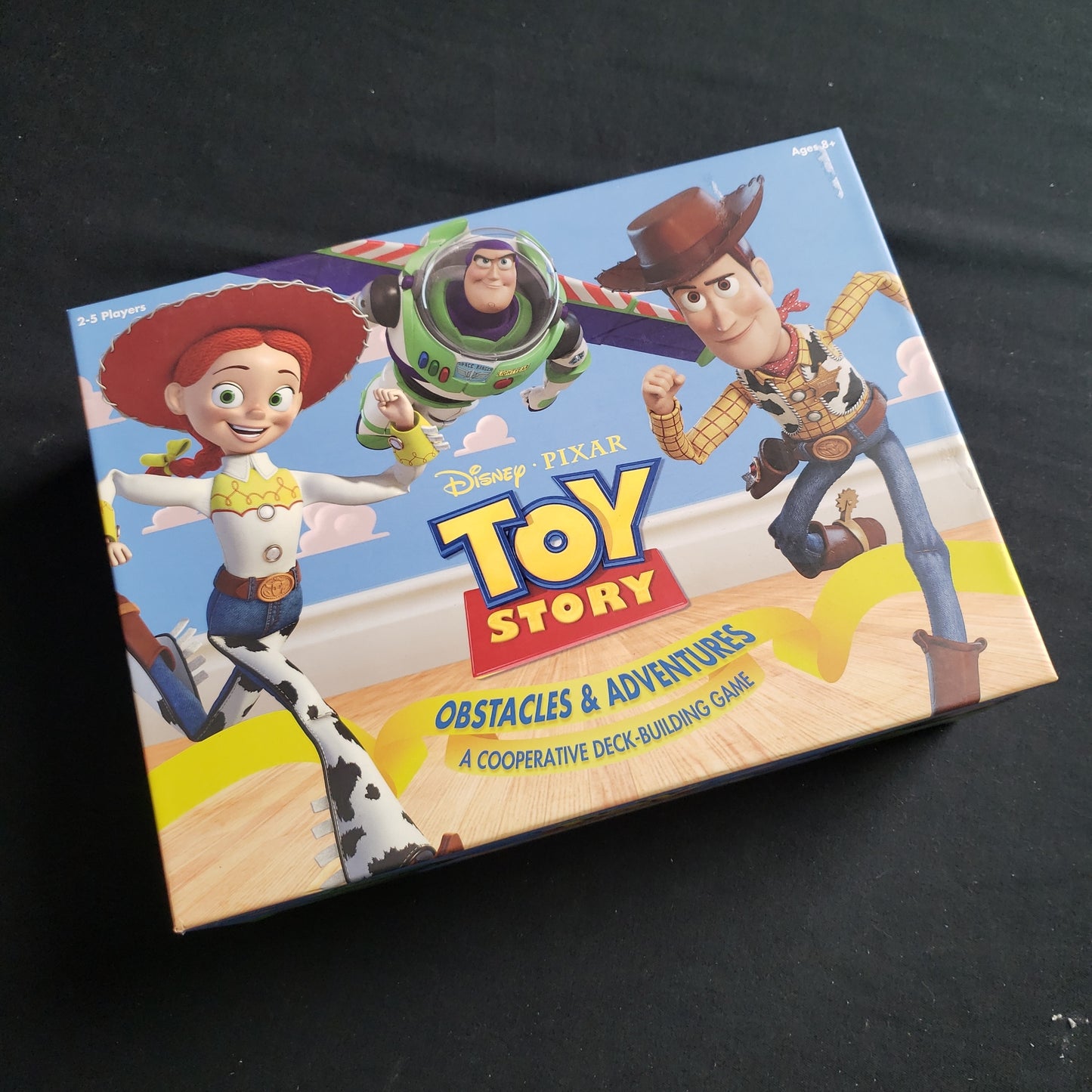 Image shows the front cover of the box of the Toy Story: Obstacles and Adventures card game