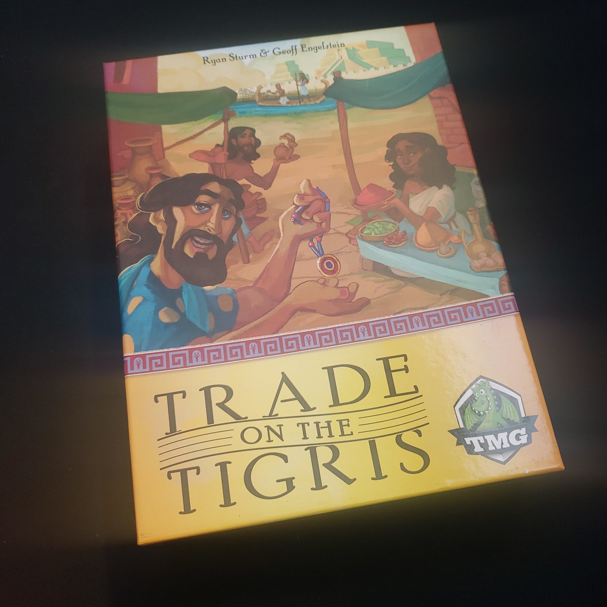 Image shows the front cover of the box of the Trade On The Tigris board game