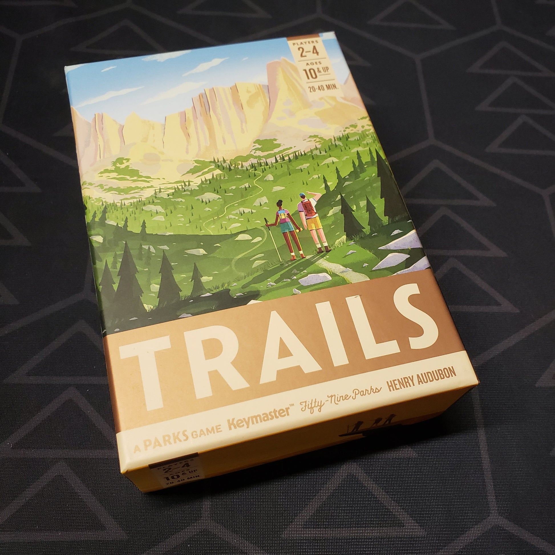 Image shows the front cover of the box for the Trails board game