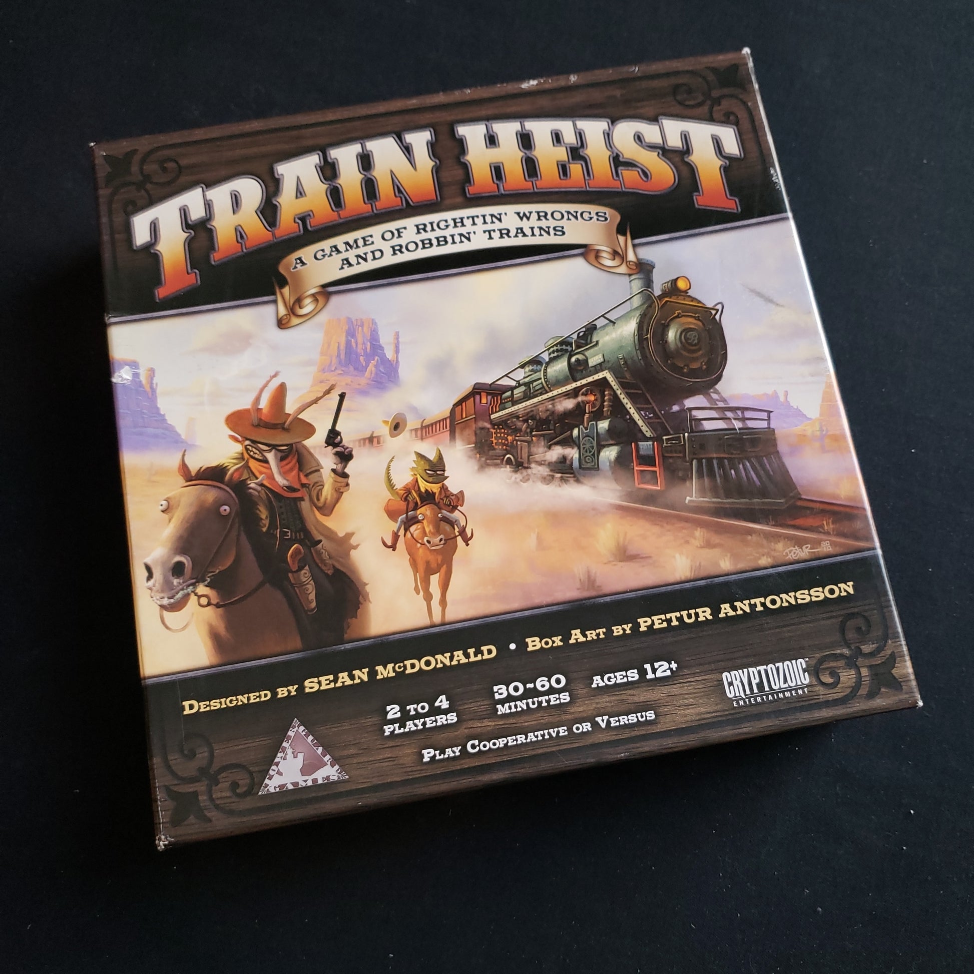 Image shows the front cover of the box of the Train Heist board game