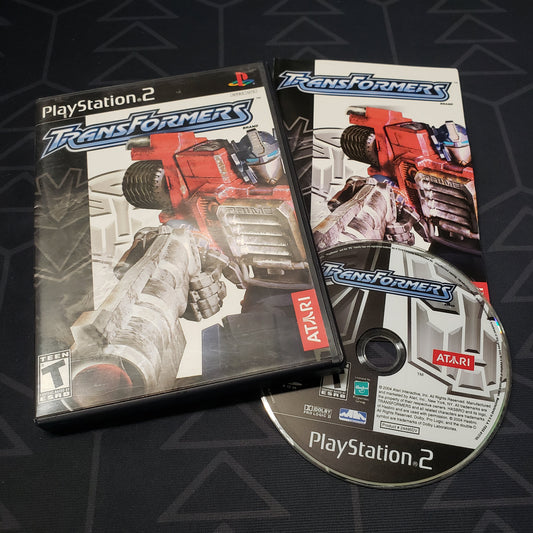 Image shows the case, manual and disc for the video game Transformers for Playstation 2