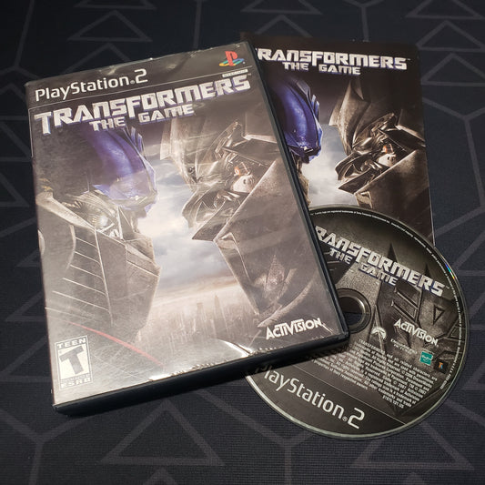 Image shows the case, manual and disc for the video game Transformers: The Game for Playstation 2