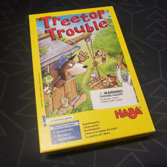 Image shows the front cover of the box for the Treetop Trouble board game
