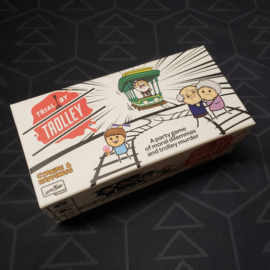 Image shows the front cover of the box for the Trial by Trolley card game