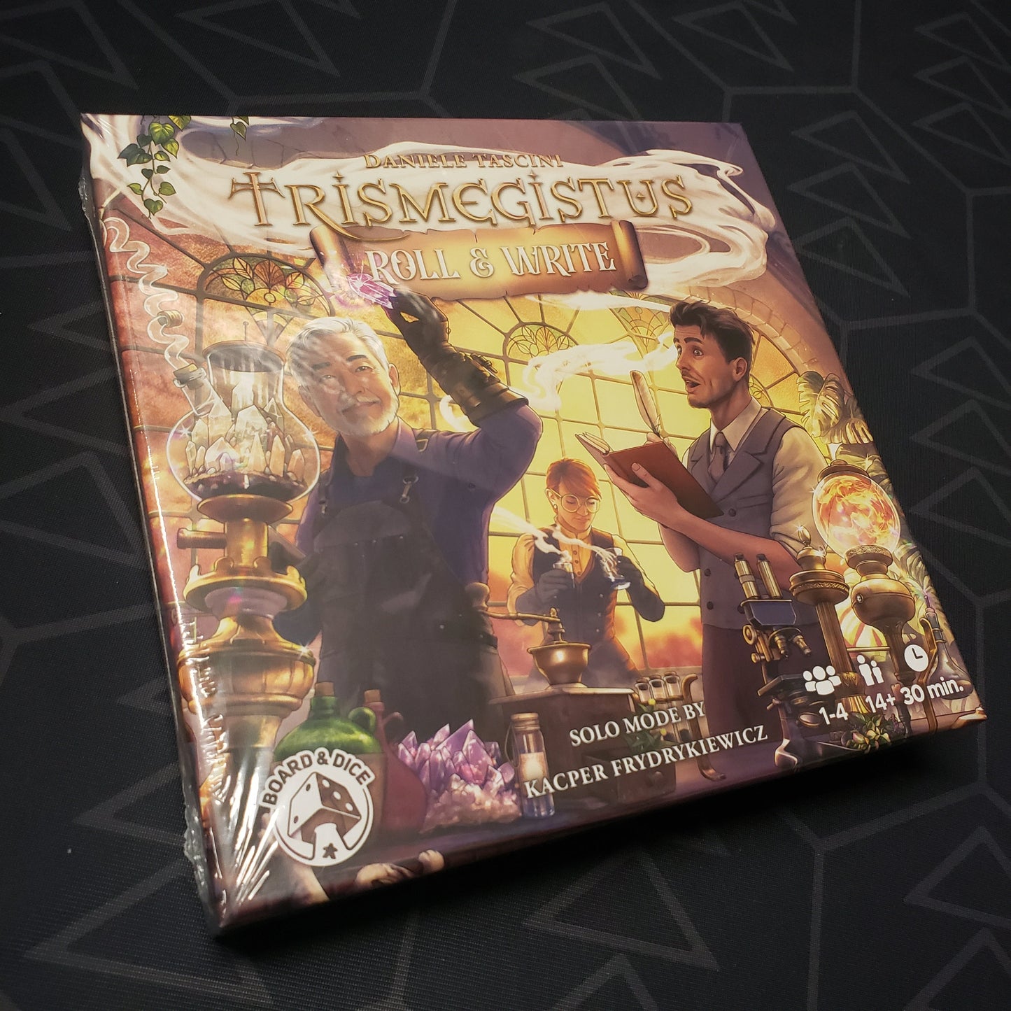 Image shows the front cover of the box for the Trismegistus: Roll & Write board game