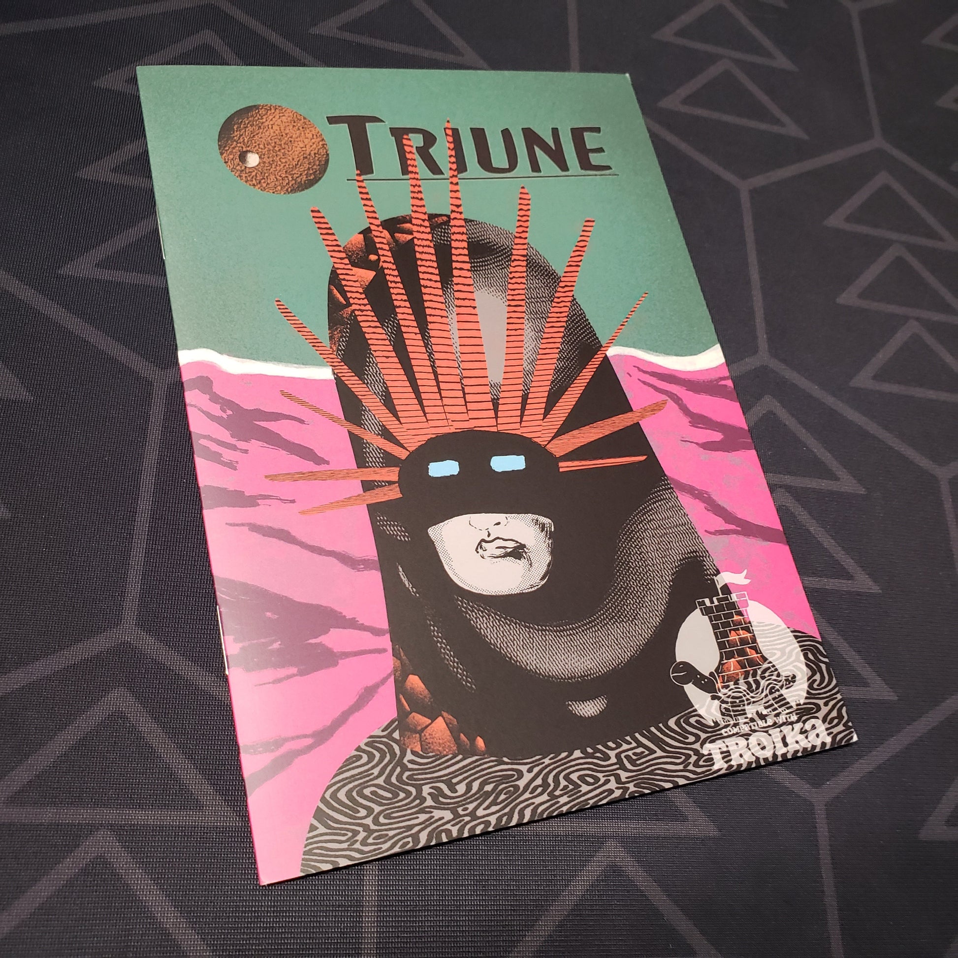 Image shows the front cover of the Triune roleplaying game book