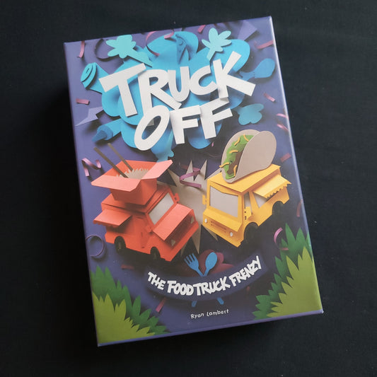 Image shows the front cover of the box of the Truck Off board game