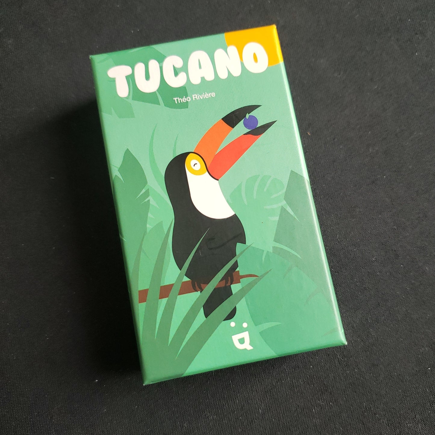 Image shows the front cover of the box of the Tucano card game