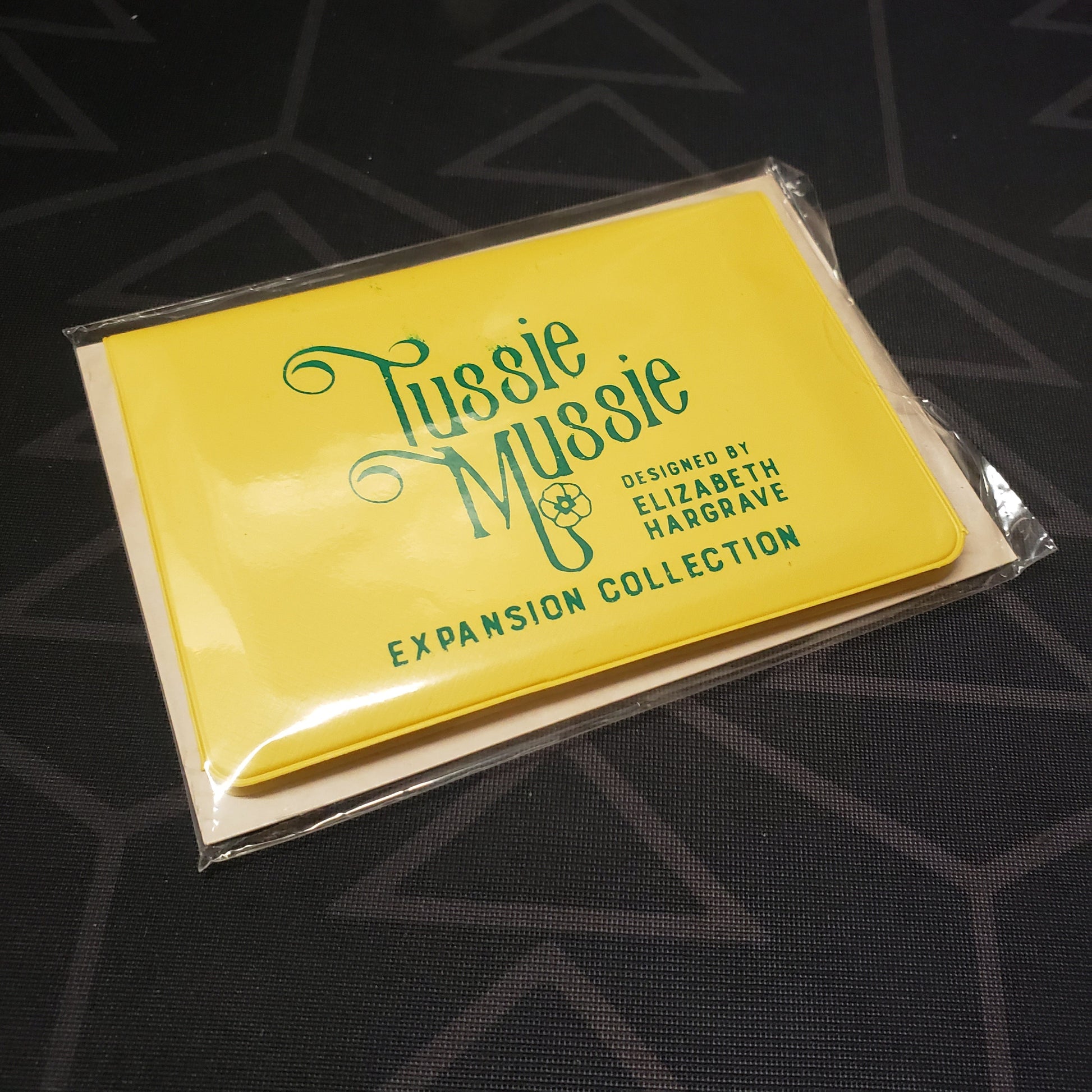 Image shows the front of the card wallet of the Expansion Collection for the card game Tussie Mussie