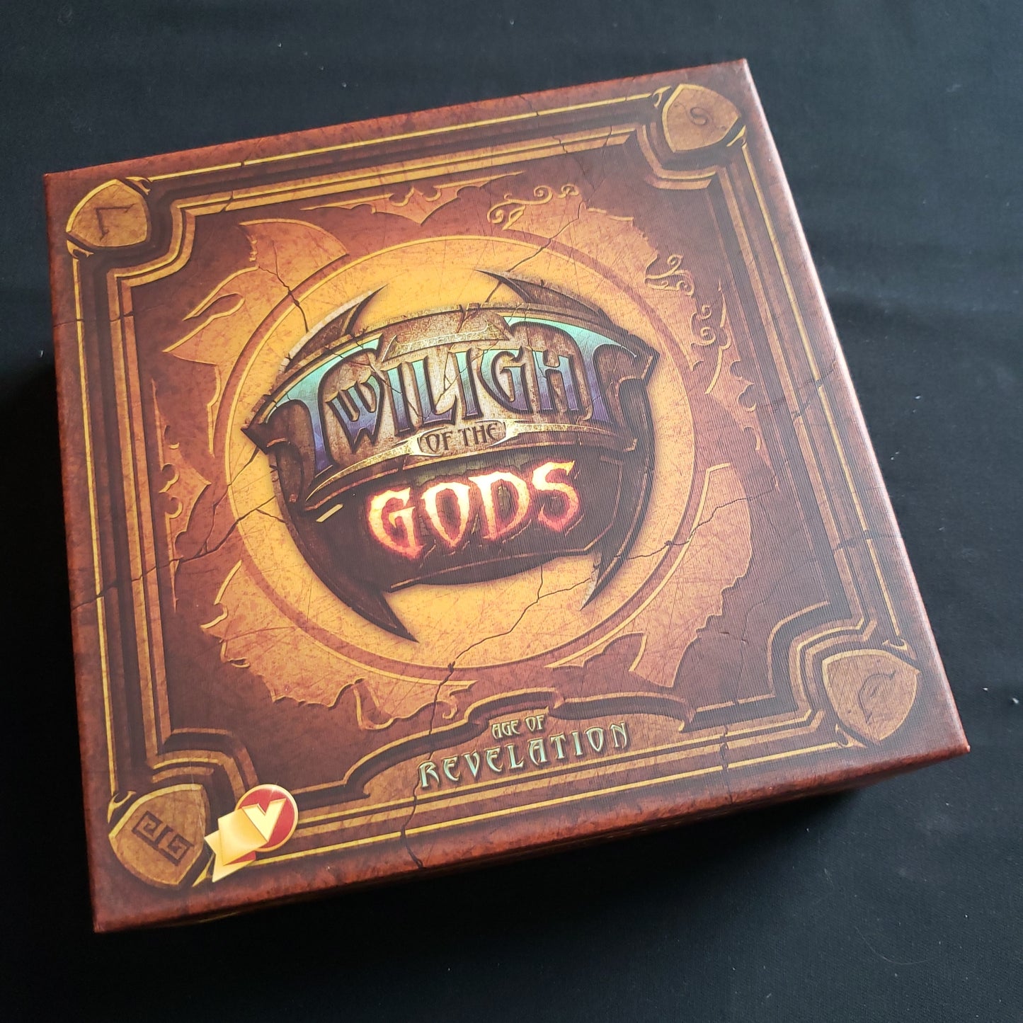 Image shows the front cover of the box of the Twilight of the Gods: Age of Revelation card game