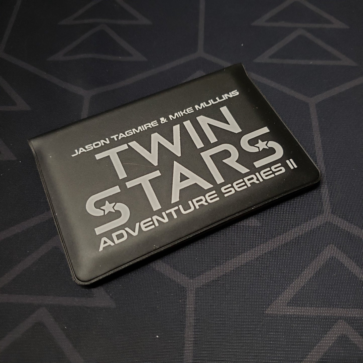 Image shows the front of the card wallet for the Twin Stars: Adventure Series II card game