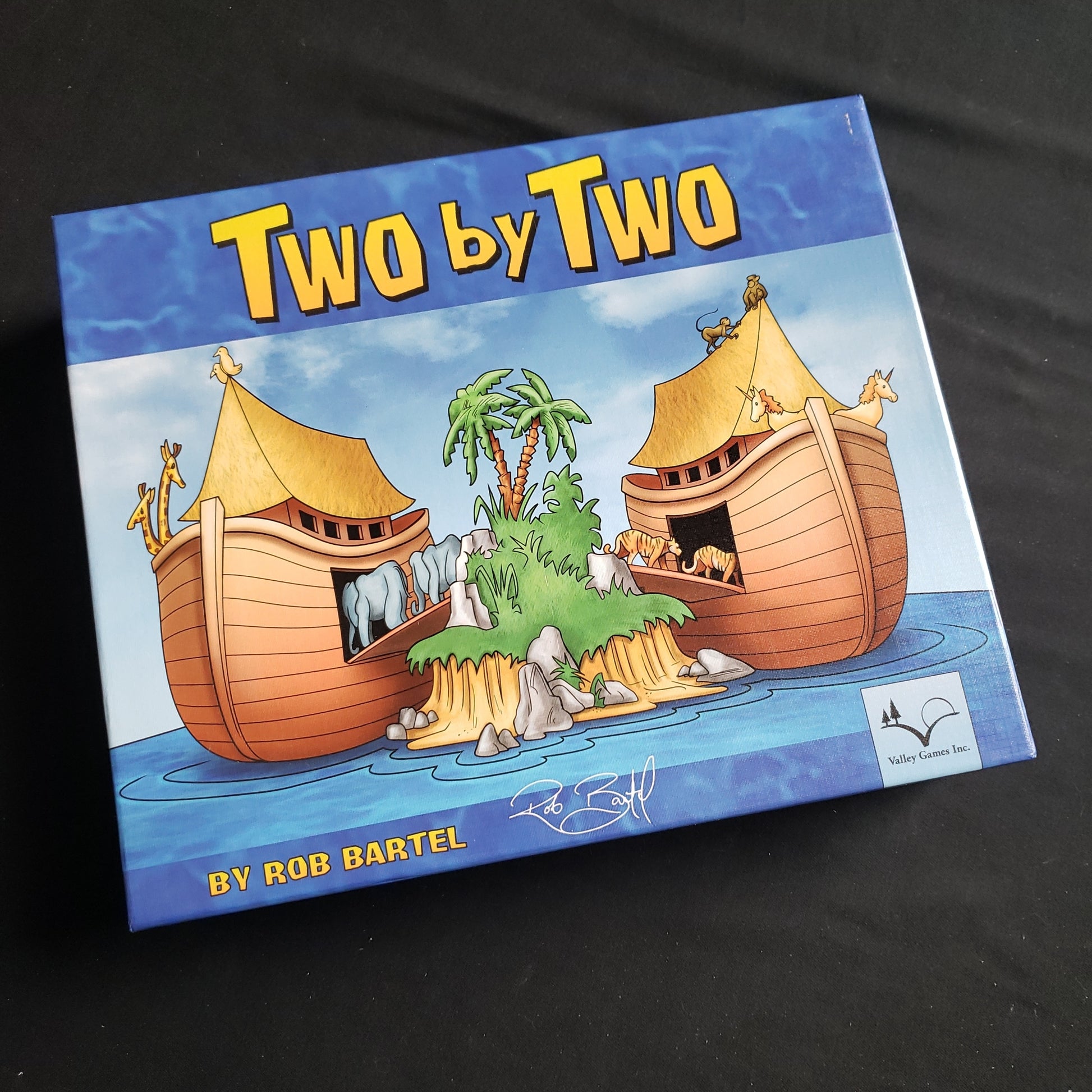 Image shows the front cover of the box of the Two by Two board game